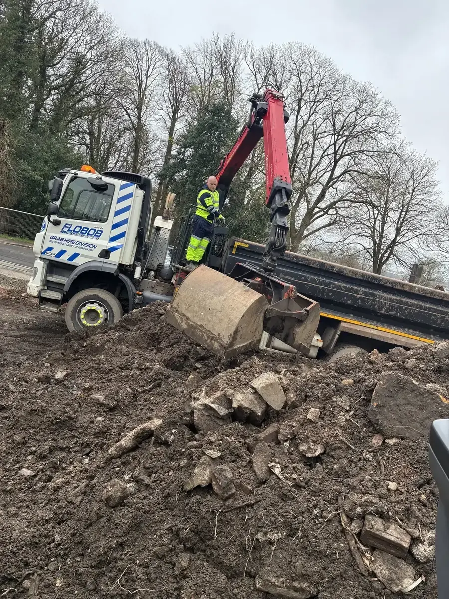 Grab Hire Scotland's red hydraulic crane collecting material